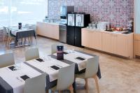a dining room with white tables and white chairs at Aparthotel Cye Holiday Centre in Salou
