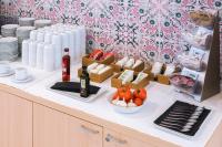 a buffet with plates and bottles of wine and food at Aparthotel Cye Holiday Centre in Salou