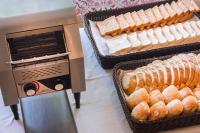 a bread maker with two baskets of bread at Aparthotel Cye Holiday Centre in Salou