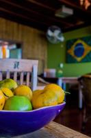 a bowl of fruit sitting on a table at Pousada DiMari in Boicucanga