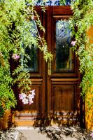 a wooden door with flowers in front of it at Pousada DiMari in Boicucanga