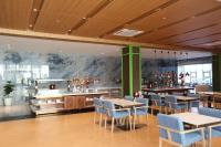 a restaurant with tables and chairs and a bar at Luxu Hotel and Resort in Panglao