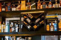 a bunch of bottles of alcohol on a shelf at Murugano Village Hotel in Taba