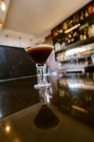 a martini glass sitting on top of a bar at Murugano Village Hotel in Taba