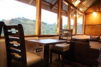 a dining room with a table and chairs and a window at The Kamcha Geodesic dome & Homestay in Bomdila