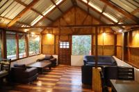 a living room with couches and a table and windows at The Kamcha Geodesic dome & Homestay in Bomdila