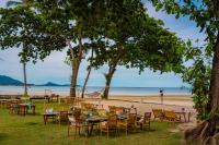 a group of tables and chairs on a beach at Tolani Resort Koh Samui in Lamai