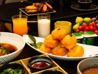 a table topped with plates of food and drinks at 烟台朝阳文保艺术酒店 in Yantai