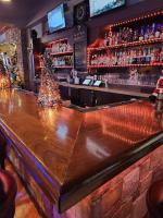a bar with a christmas tree on the counter at The Plaza Hotel Downtown, Trademark Collection by Wyndham in Kamloops