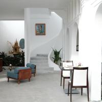 a living room with a table and chairs at Serenity Angkor in Phum Pobos