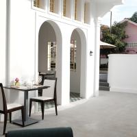 a dining room with a table and chairs on a patio at Serenity Angkor in Phum Pobos
