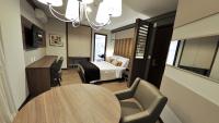 a hotel room with a bed and a table and chairs at Klein Ville São Leopoldo in São Leopoldo