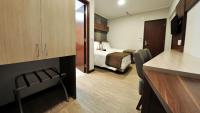 a small hotel room with a bed and a kitchen at Klein Ville São Leopoldo in São Leopoldo