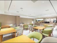 a classroom with tables and chairs and a cafeteria at JI Hotel Shanghai International Tourism Resort Chongxi Road in Nanhui