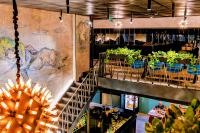 a restaurant with a staircase and tables and chairs at Billionare In Alliance Palace in Batumi