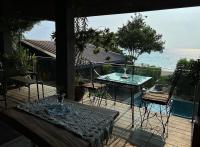 a patio with a table and chairs and a view of the ocean at Eliseos Bed & Kitchen in San Juan