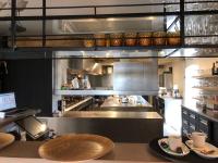 a large industrial kitchen with a table and chairs at De Kruishoeve in De Haan