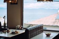 a dining room with a table and a large window at Suu -瀬戸内の小さな別邸 in Futami