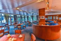 a restaurant with tables and chairs and a bar at Poets Cove Resort & Spa in Bedwell Harbour