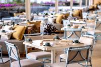 a row of tables and chairs in a restaurant at Ka Laʻi Waikiki Beach, LXR Hotels & Resorts in Honolulu