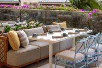 a table and two chairs and a couch on a patio at Ka Laʻi Waikiki Beach, LXR Hotels & Resorts in Honolulu