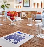 a wooden table with a bowl of apples on it at Delamar 4*Sup-Adults only (18+) in Lloret de Mar