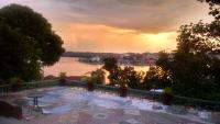 a view of a river with a sunset in the background at Zapote Tree Inn in Flores
