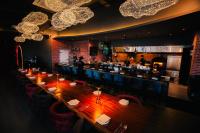 a long table in a restaurant with a bar at Panorama luxury Suites At TM Persiaran Stonor KLCC in Kuala Lumpur