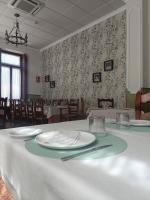 a dining room with a table with plates on it at Villa Manolita in Fuensanta