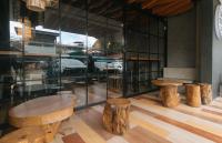 a room with tables and logs in a building at Avelida Homes by RedDoorz in Iloilo City