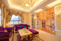 a living room with purple furniture and a chandelier at Sophia B&amp;B in Dongshan