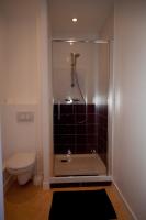 a shower stall in a bathroom with a toilet at Hotel au Moyne De Saire in Réville