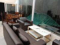 a living room with a couch and a table at TTN - The Trekker's Nest in Joshīmath