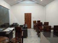 a dining room with tables and chairs and a door at TTN - The Trekker's Nest in Joshīmath