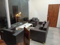 a living room with two couches and a table at TTN - The Trekker's Nest in Joshīmath