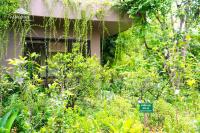 a garden with a sign in front of a house at Van long garden retreat in Kon Rung (1)