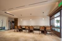 a dining room with a table and chairs at Jiuhua Goodstay Inn in Chizhou