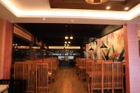 a dining room with wooden tables and chairs at Igloo Heritage Resorts in Idukki