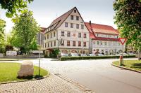 a large building on a street with a rock at Ringhotel Gasthof Hasen in Herrenberg