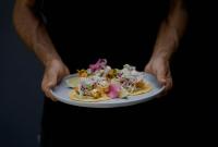 a person is holding a plate of food at Hotel Nya in Montezuma