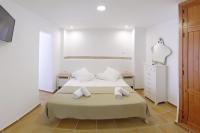 a bedroom with a bed with two towels on it at Apartamentos Gravina in Tarifa