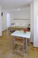 a room with a table and a bed at Apartamentos Gravina in Tarifa