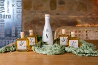 a group of four bottles of oils on a table at Hotel Boutique Patio del Posadero in Córdoba