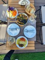 a picnic table with plates of food on it at Sky Dome - Alushllari's Farm in Pogradec