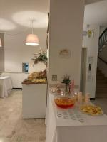 a table with plates of food on it in a room at Hotel Villa Nicole in Pietra Ligure