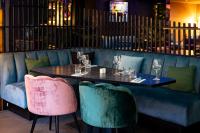 a dining room with a table and two chairs at Hotel Xanadu in London