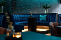 a living room with a blue couch and a table at Hotel Xanadu in London