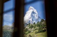 a view of a mountain through a window at Grand Hotel Zermatterhof in Zermatt