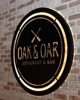 a sign for a restaurant and bar on a brick wall at The Geneva Inn in Lake Geneva