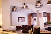 a dining room with a table with a laptop on it at Hotel Altos del Norte in San Miguel de Tucumán